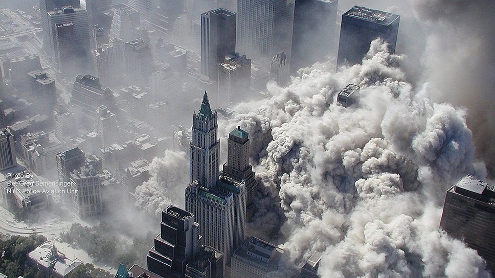 Вид с самолета на обрушивающиеся в результате теракта 9/11 башни-близнецы Всемирного Торгового Центра