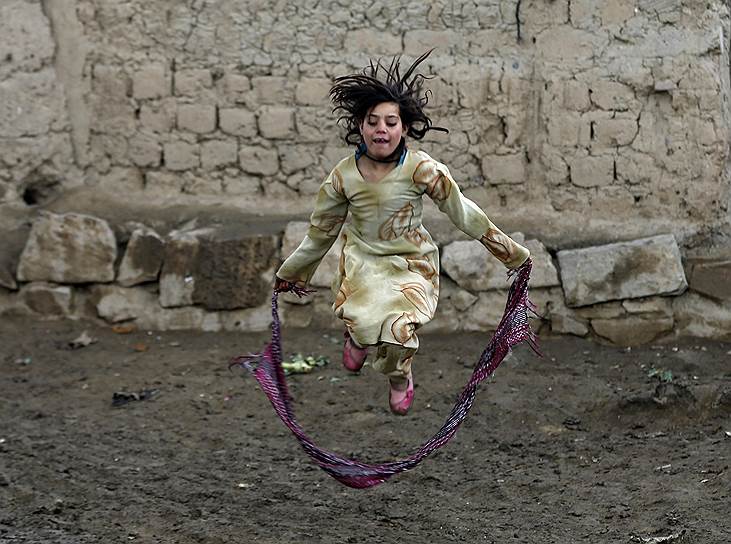 Кабул, Афганистан. Девочка играет рядом с лагерем для беженцев из других районов страны