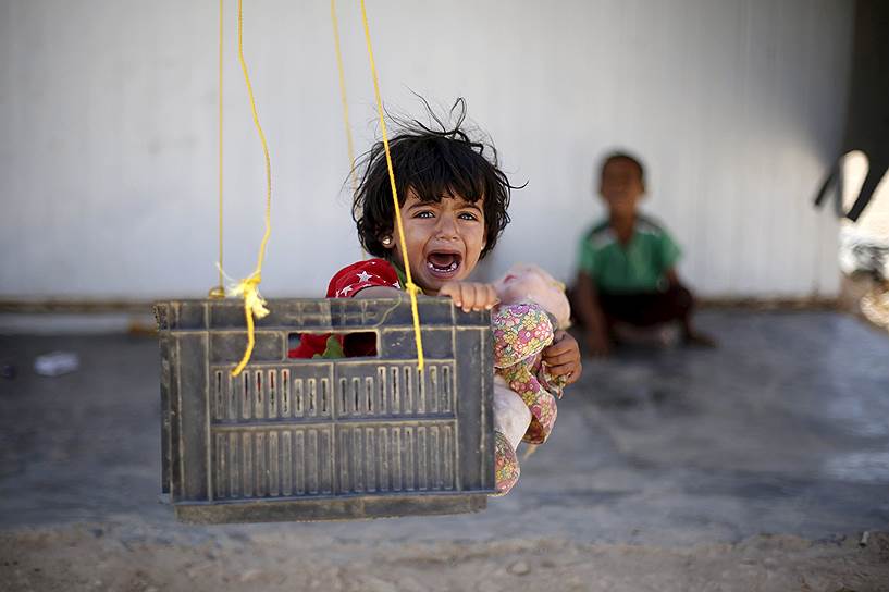 Эль-Мафрак, Иордания. Ребенок на качели в лагере беженцев «Затаари»