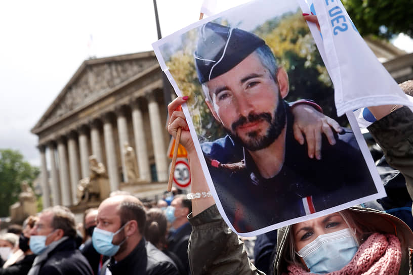 Женщина с фотографией бригадира Эрика Массона на акции протеста во Франции 