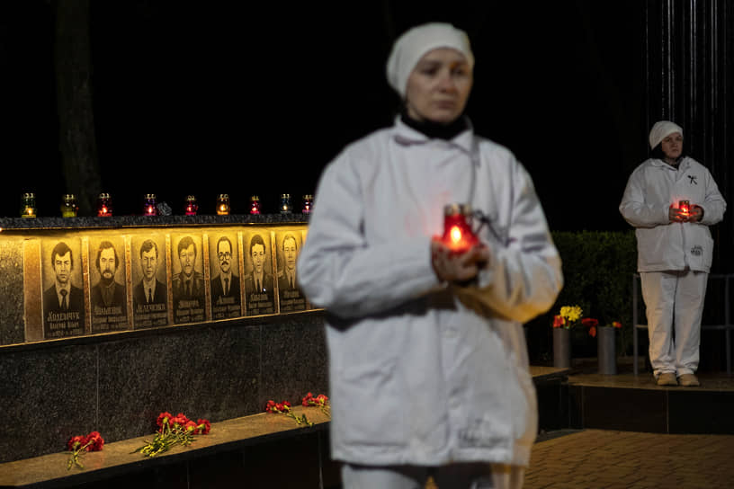 Славутич, Украина. Сотрудники Чернобыльской АЭС держат свечи у мемориала жертвам Чернобыльской аварии в годовщину ядерной катастрофы