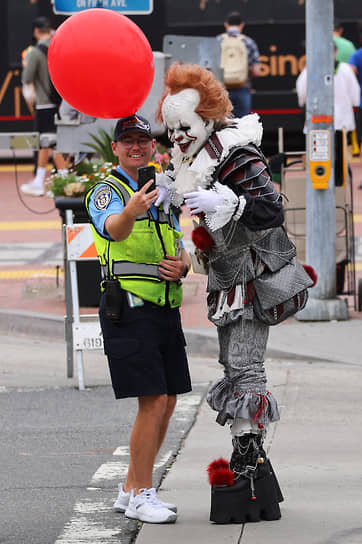 Сотрудник дорожной инспекции Сан-Диего позирует с человеком в образе клоуна Пеннивайза 