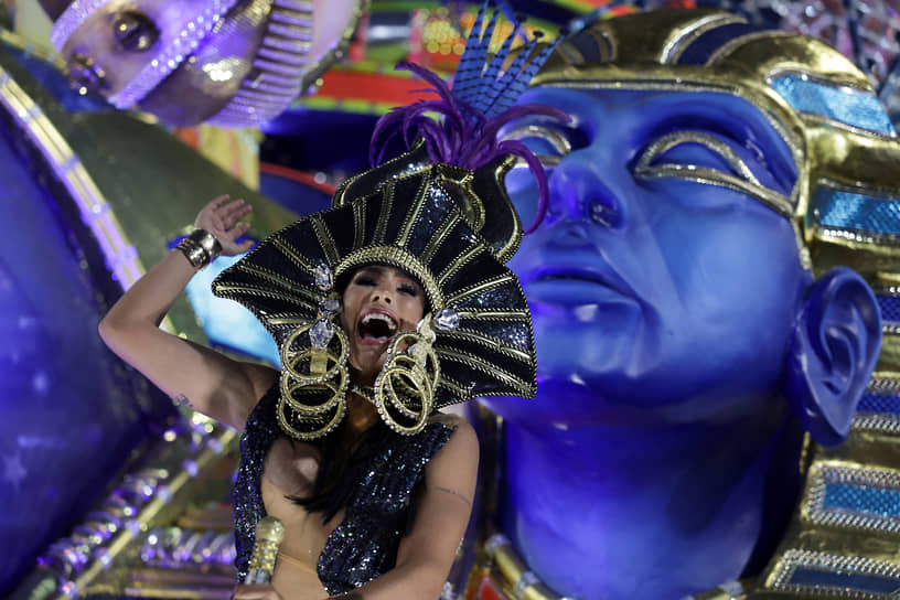 Рио-де-Жанейро, Бразилия. Участница традиционного карнавала танцует во время ночного парада
