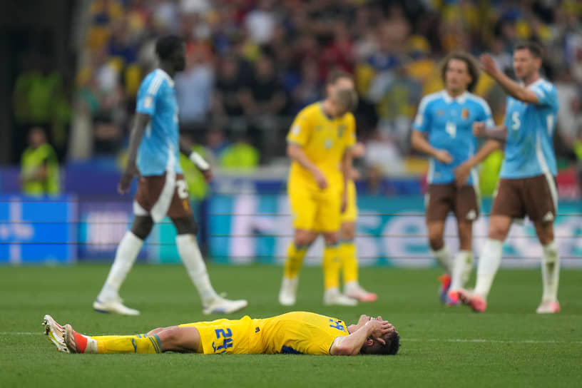 Защитник сборной Украины Александр Тымчик лежит на поле после ничьей с Бельгией (0:0) и вылета из чемпионата 