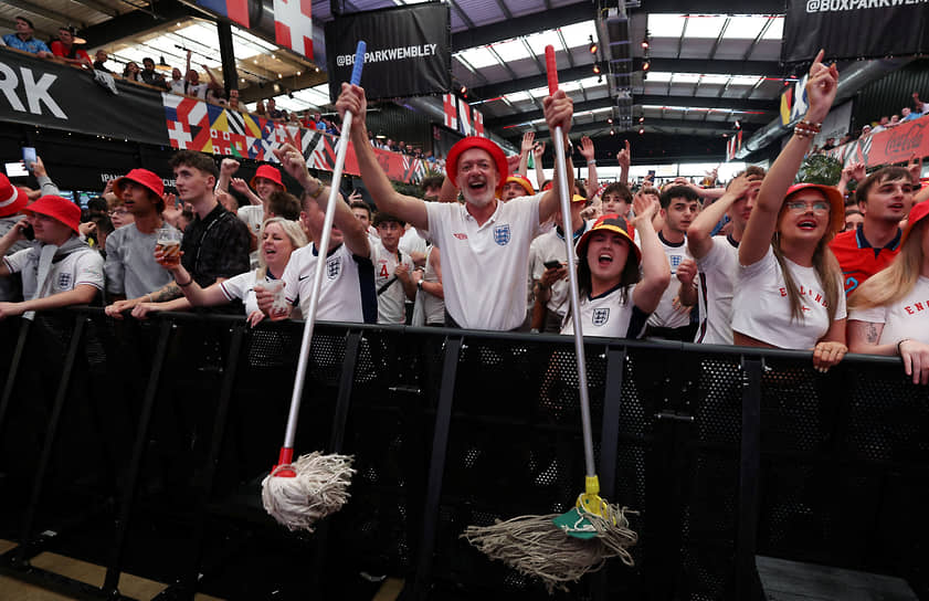 Болельщики сборной Англии смотрят матч против Словакии в фан-зоне BoxPark Wembley в Лондоне 