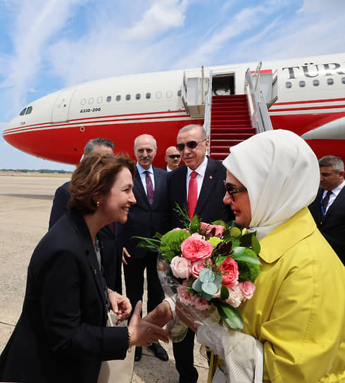 Президента Турции Реджепа Тайипа Эрдогана (в центре) и его супругу Эмине Эрдоган (справа) приветствуют члены турецкого посольства в США на авиабазе Эндрюс