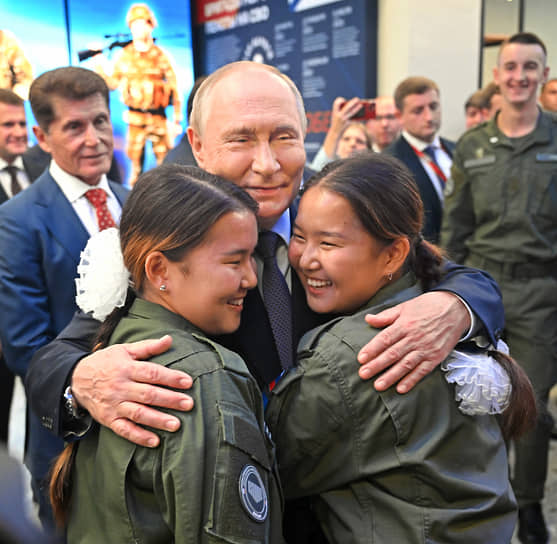 Президент России Владимир Путин (в центре), губернатор Приморского края Олег Кожемяко (слева) и курсанты Центра военно-спортивной подготовки и патриотического воспитания «Воин» в филиале Национального центра «Россия», Владивосток