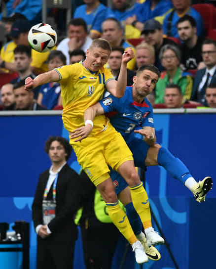 Игрок сборной Украины Александр Зинченко (слева) и игрок сборной Словакии Петер Пекарик во время матча
