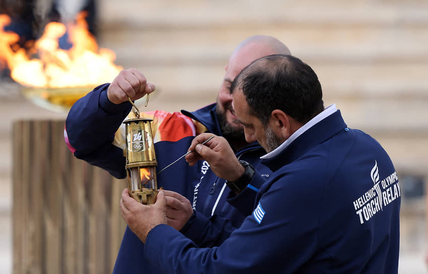 Члены сборной Греции с олимпийским огнем