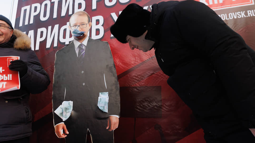 Участники митинга против повышения тарифов ЖКХ у картонной фигуры председателя РЭК Свердловской области Владимира Гришанова