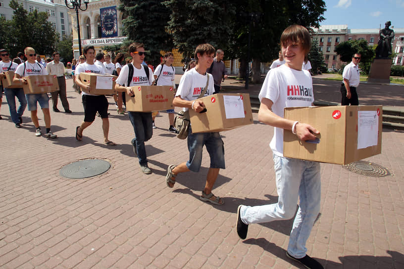 Активисты несут коробки с подписями, собранными в поддержку прямых выборов мэра