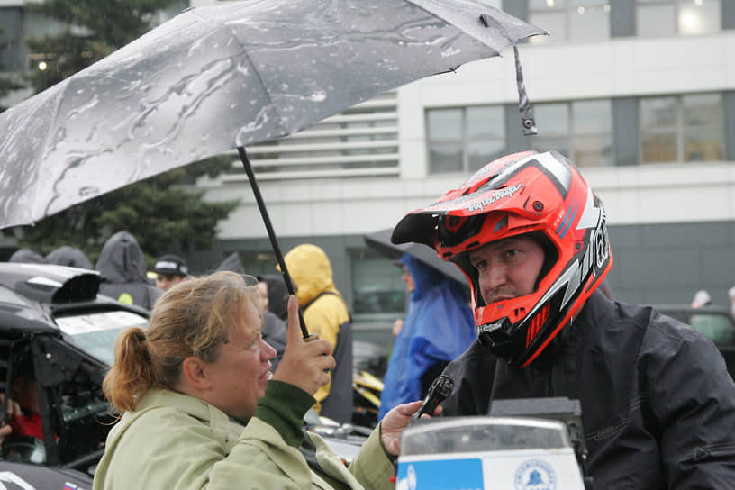 Журналист берет интервью у гонщика