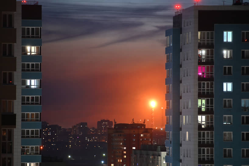 Факел на Омском нефтеперерабатывающем заводе (НПЗ) и многоэтажные жилые дома