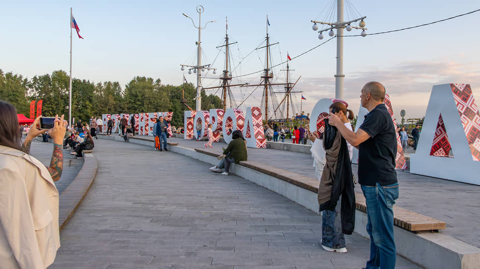 Гости отдыхают у стеллы «Город-сад» в финале первого дня фестиваля