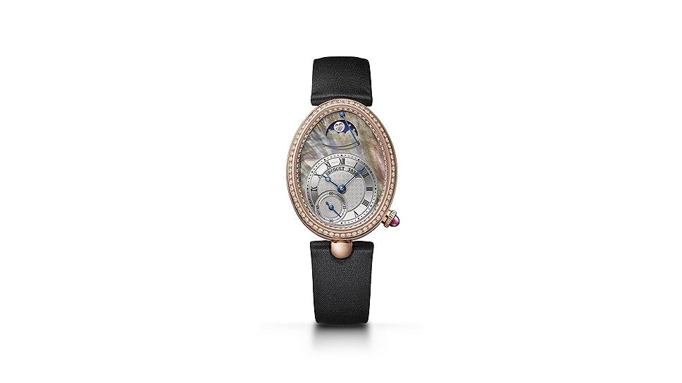 Breguet Reine de Naples. Гильошированный циферблат из таитянского перламутра и посеребренного золота. Корпус 36,50x28,45 мм из розового золота. Кольцо и обод циферблата украшены инкрустацией из 128 бриллиантов (весом около 0,77
карата). Заводная головка с неограненным рубином (около 0,27 карата). Задняя крышка из сапфирового стекла